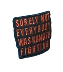 Close-up of a black and red embroidered patch reading “Surely not everybody was kung fu fighting”, featured on an original SMC garment "Cold Chains".