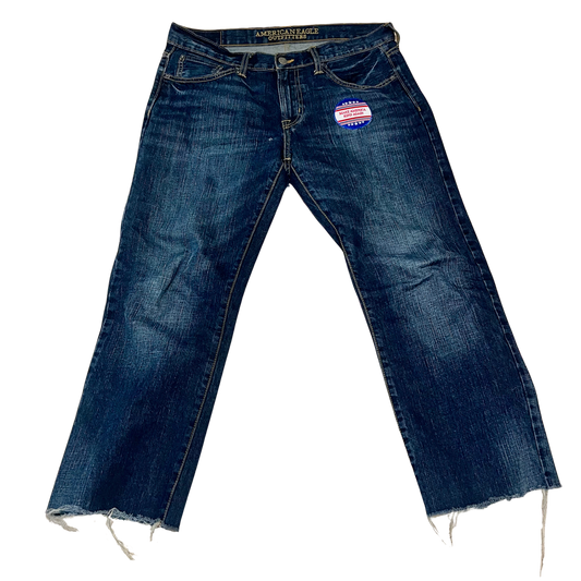 One-of-a-kind SMC jeans titled “Make America Kind,” featuring a raw hem and a red, white, and blue embroidered patch that reimagines political messaging with a softer, more human ethos.