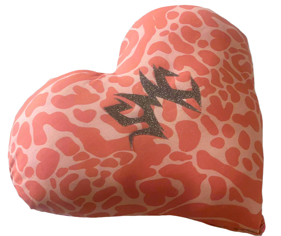 One-of-a-kind heart-shaped SMC pillow featuring a bold two-tone pink animal print pattern and adorned with the sparkly silver SMC sigil — a handmade artifact from the Secret Mystic Collection.