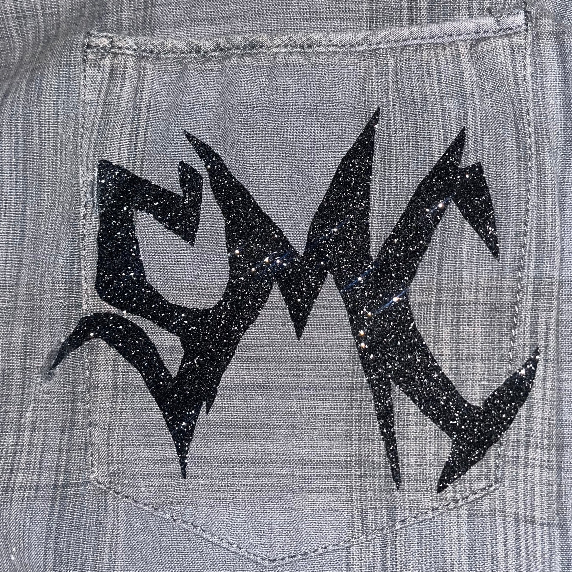 Close up of the sparkling SMC sigil adorned on the one-of-one "Grey Matter" button-up shirt by SMC