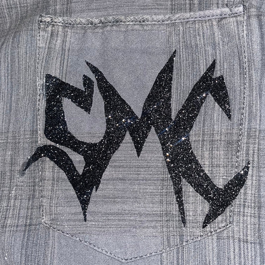 Close up of the sparkling SMC sigil adorned on the one-of-one "Grey Matter" button-up shirt by SMC